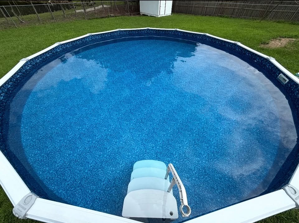 Round above-ground pool with clean blue water in a backyard