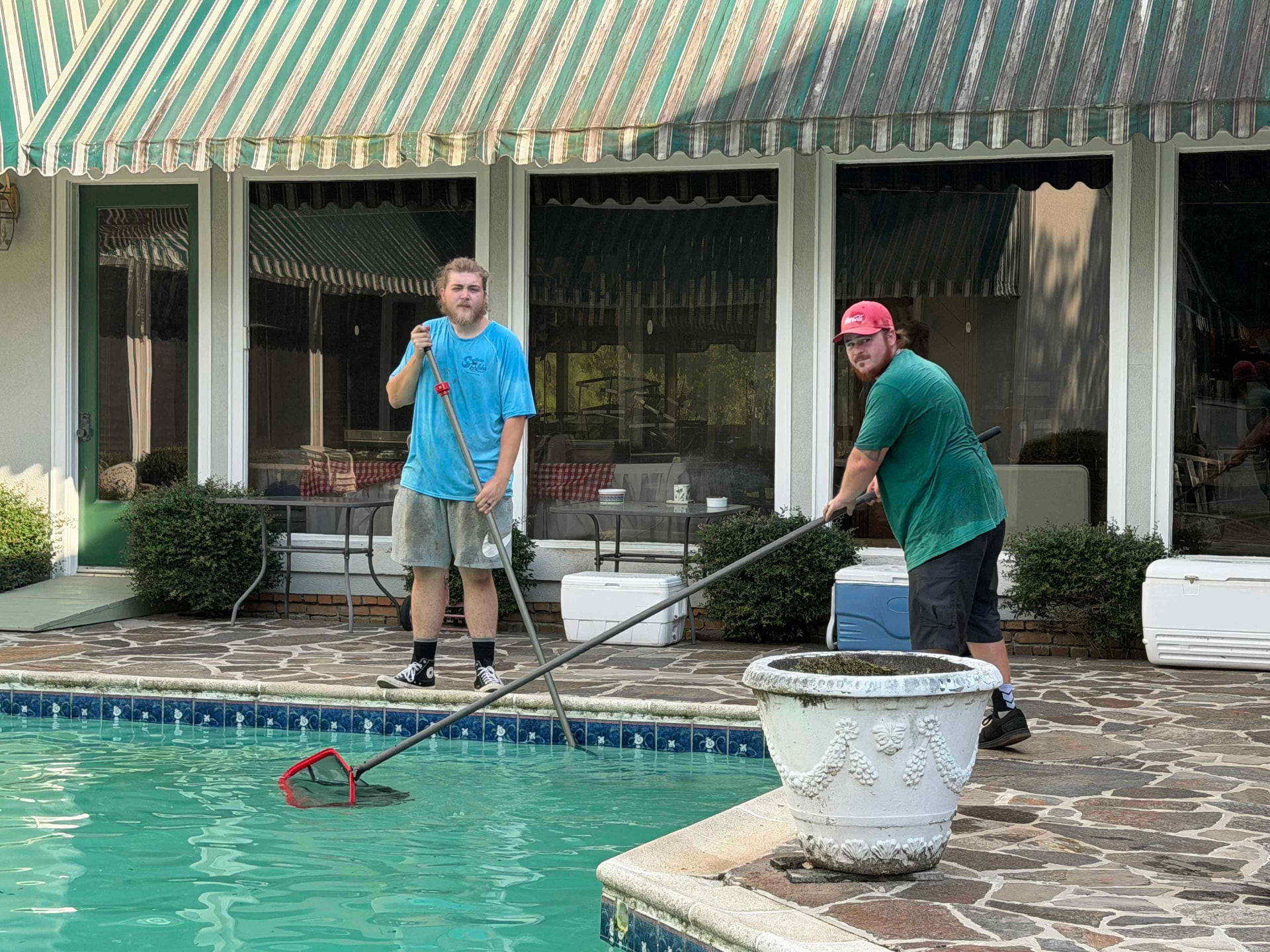 Southern Aloha Pools technicians servicing a residential swimming pool